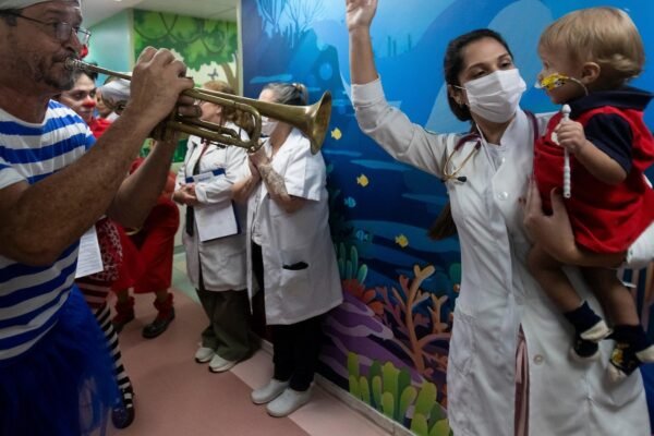 Clowns and musicians bring the joy of the carnival to sick children in a river hospital