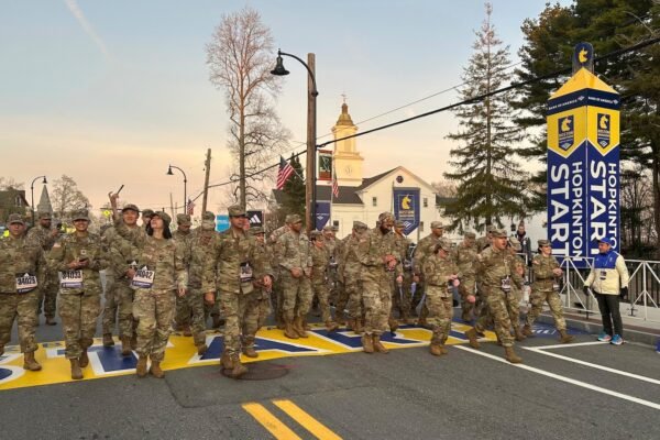 Military protesters left Hopkinton to start the 129th Boston Marathon