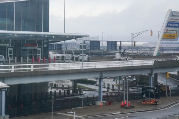 Surveillance video shows New York's flight to Paris Stowaway sliding the door agents